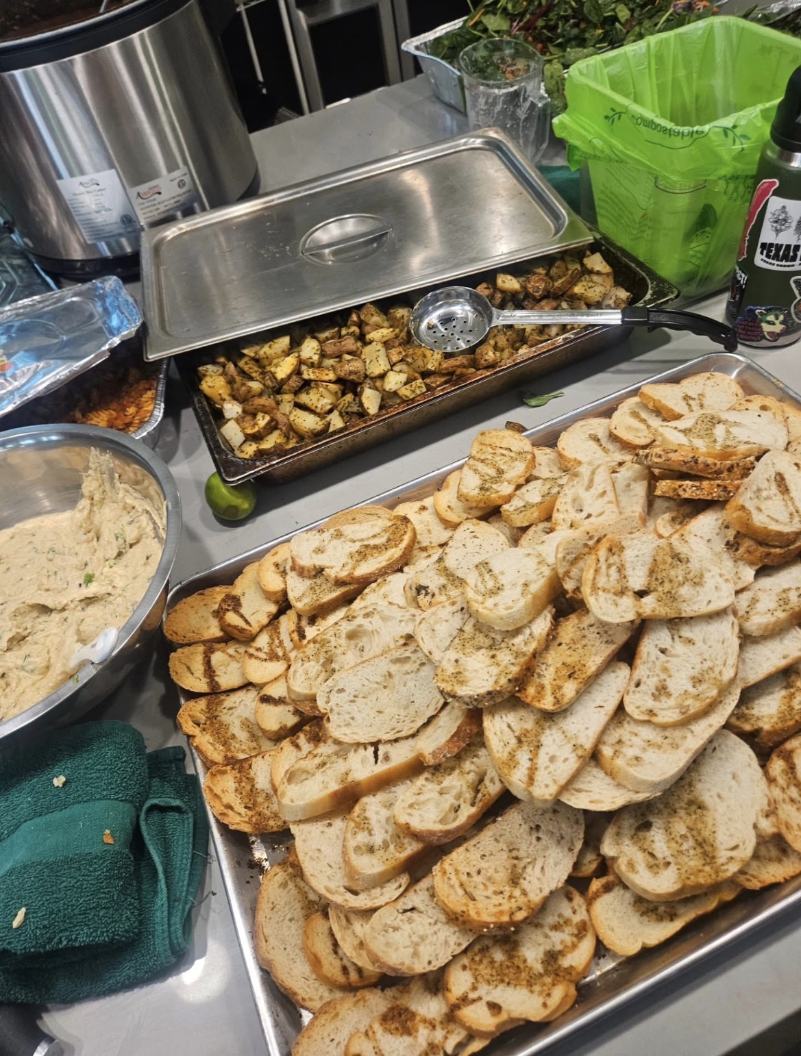 Prepared bread and roasted potatoes on a kitchen prep table